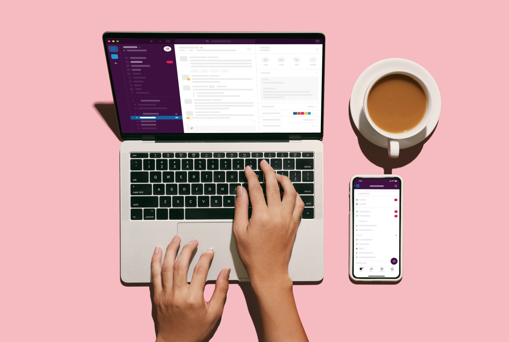 اسلک Slack روی لپتاپ کنار موبایل و فنجان قهوه